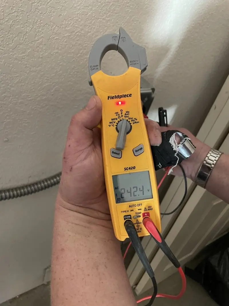 Voltage testing with clamp meter during Recessed Lighting Installation in North Andover